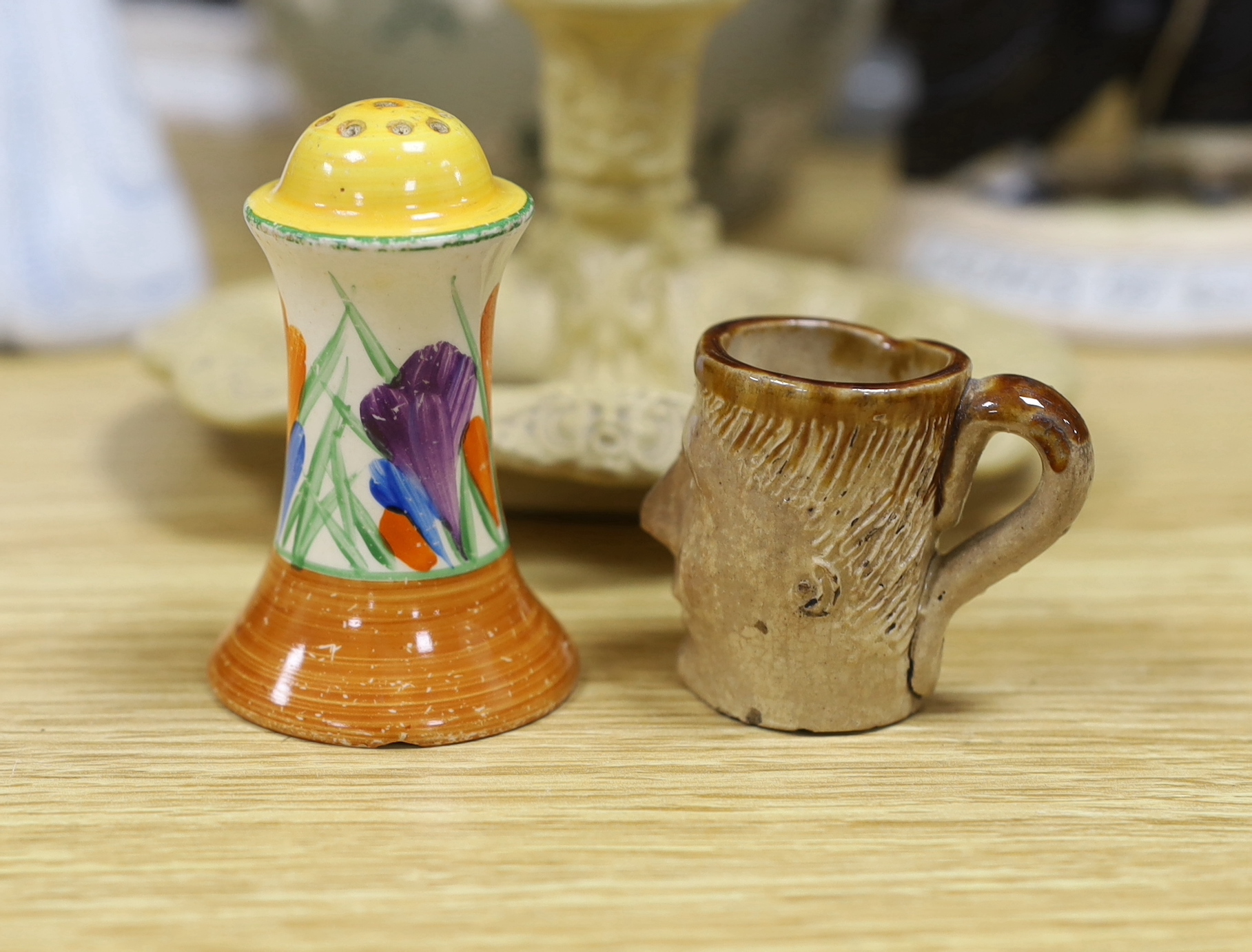 A Royal Doulton mug, two figures and a jar, a Clarice Cliff pepper and four other items (9), tallest Ballon Boy 20cm high